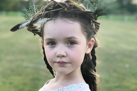 girl wearing a wreath crown on her head