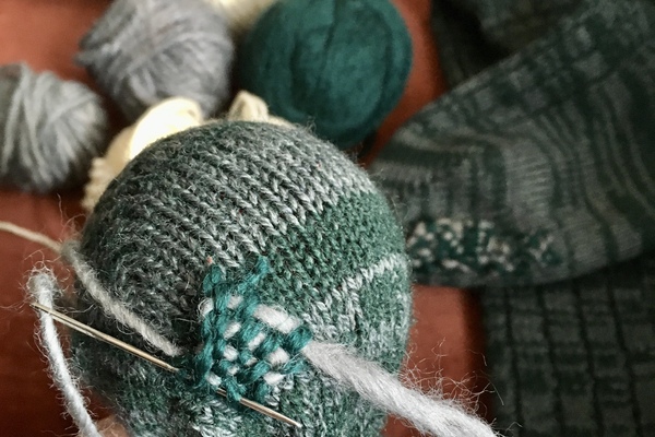 sock repair. ball of yarn and needle.