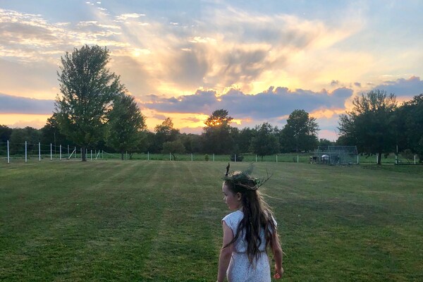 Girl in field with sunset